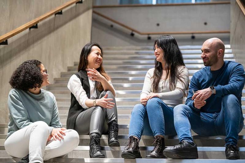 Students sitting and chatting on stairs