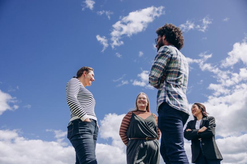 Group of students gathered under summer skies