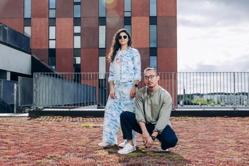 Two students in front of university building